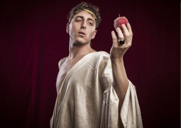 A Shakespearean actor holding an apple