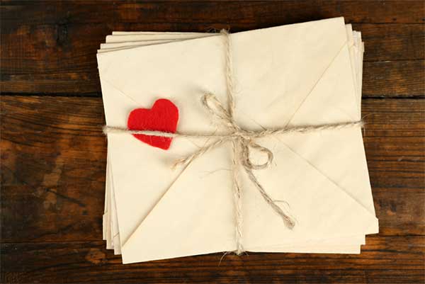 A tied up bundle of letters with a heart